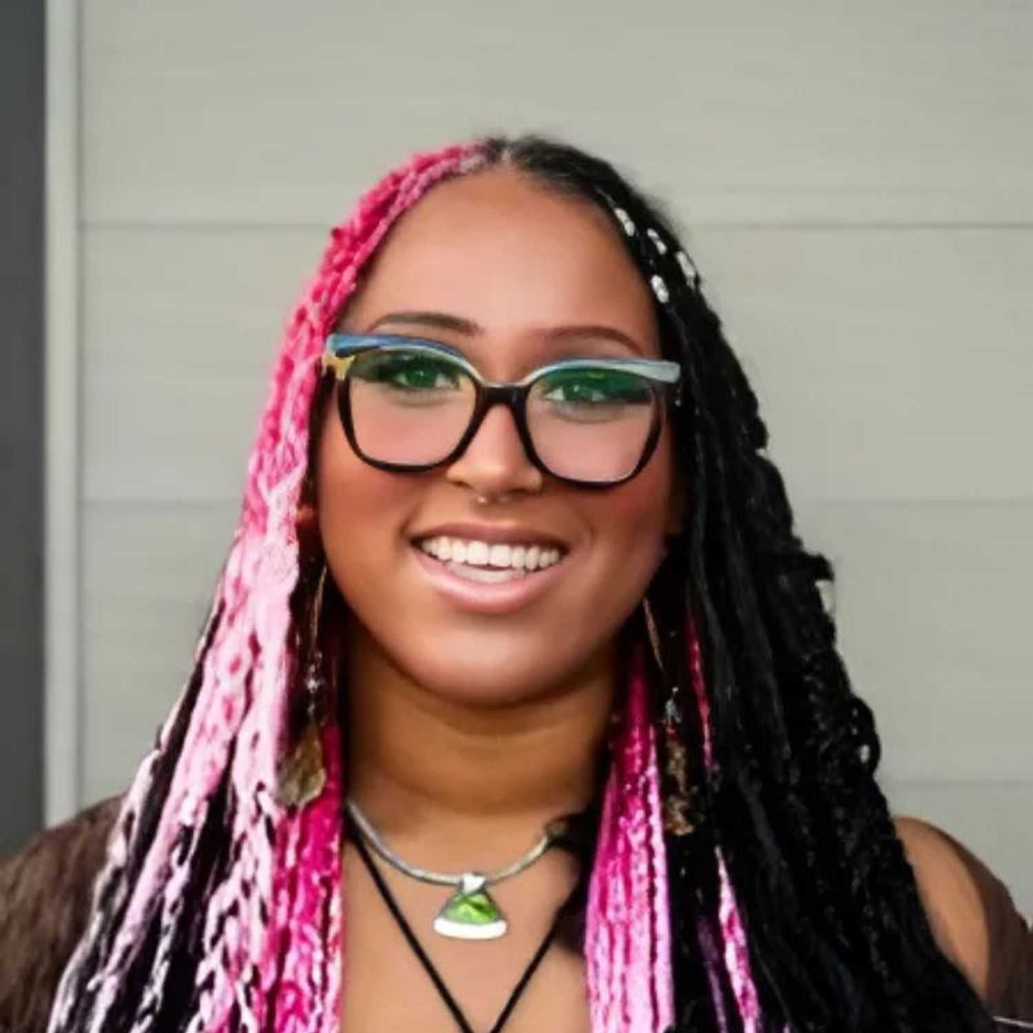 Portrait of Ayanna, a professional stylist at Head over Heels Salon, showcasing their expertise and style.