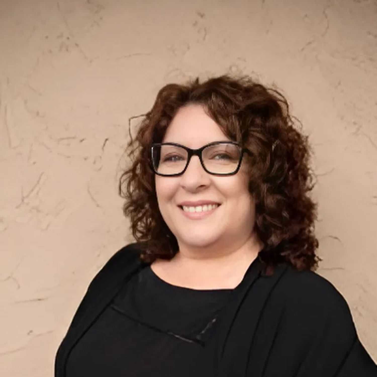 Portrait of Tina, a professional stylist at Head over Heels Salon, showcasing their expertise and style.