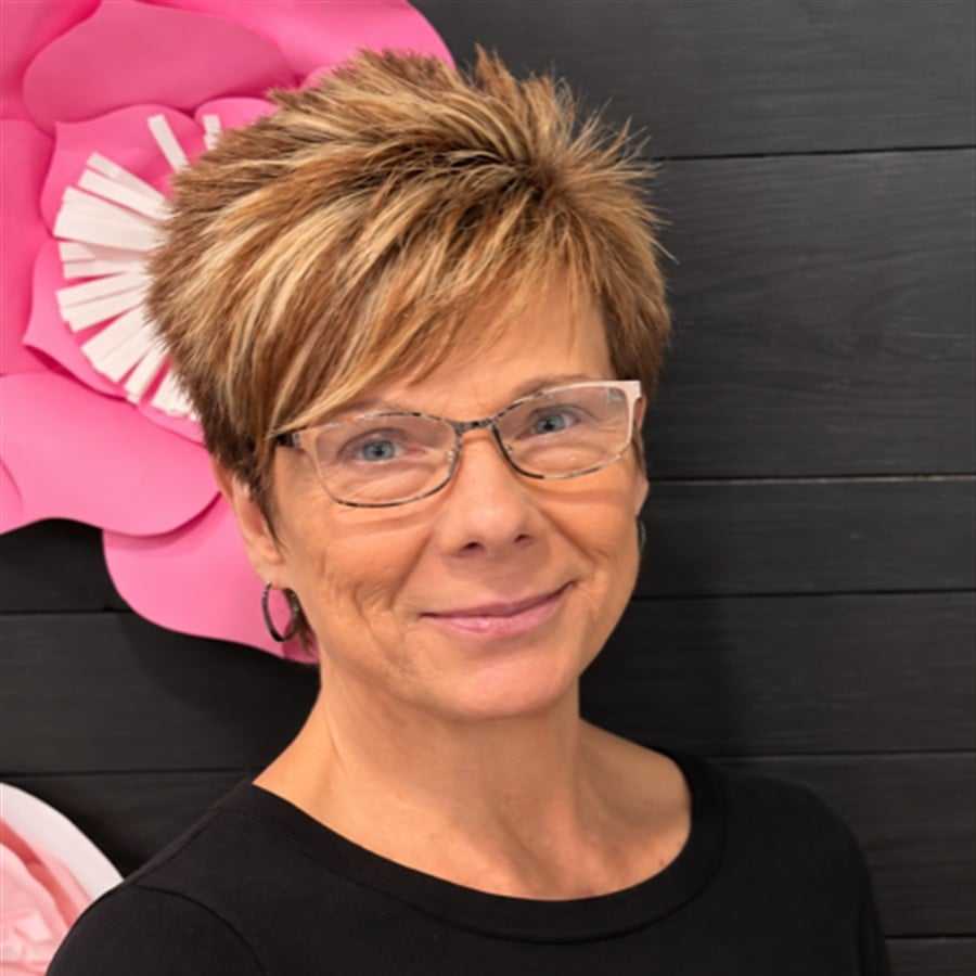 Portrait of Denise, a professional stylist at Head over Heels Salon, showcasing their expertise and style.