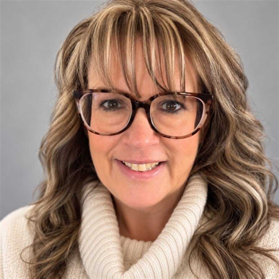 Portrait of Carol, a professional stylist at Head over Heels Salon, showcasing their expertise and style.