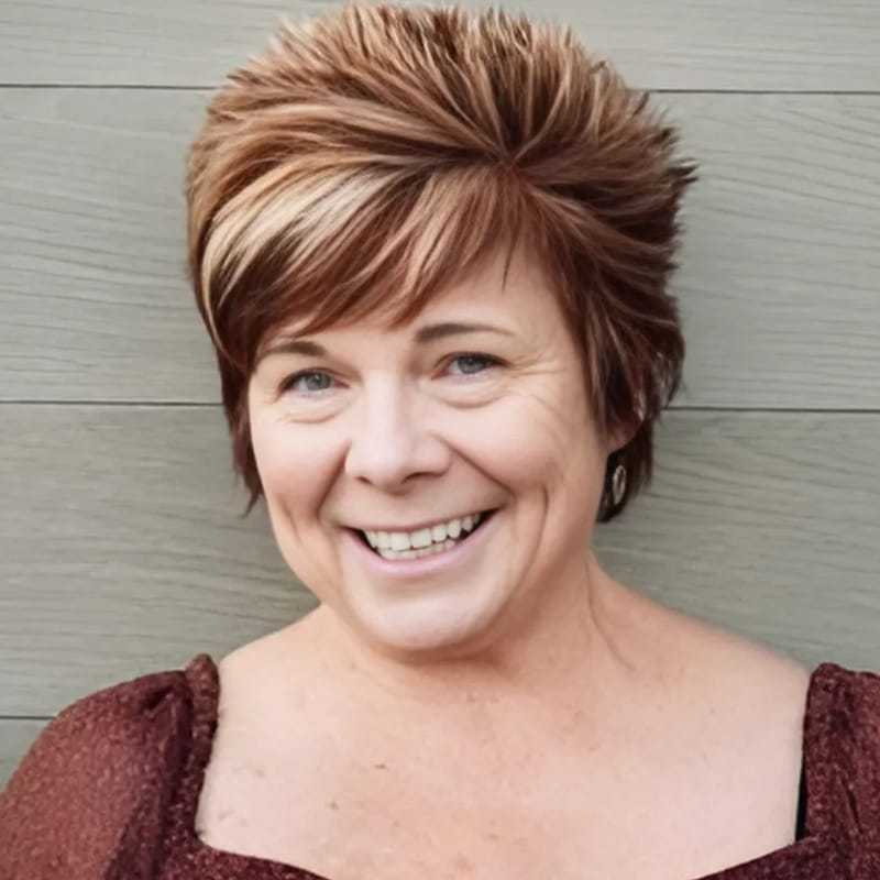 Portrait of Denise, a professional stylist at Head over Heels Salon, showcasing their expertise and style.