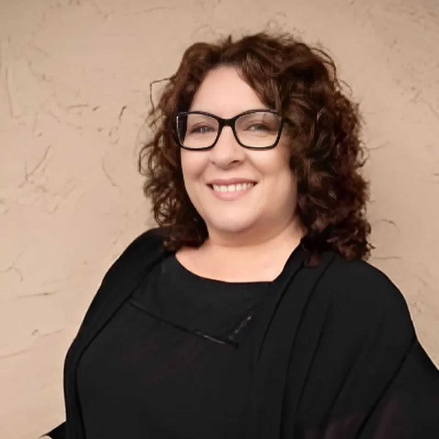 Portrait of Tina, a professional stylist at Head over Heels Salon, showcasing their expertise and style.