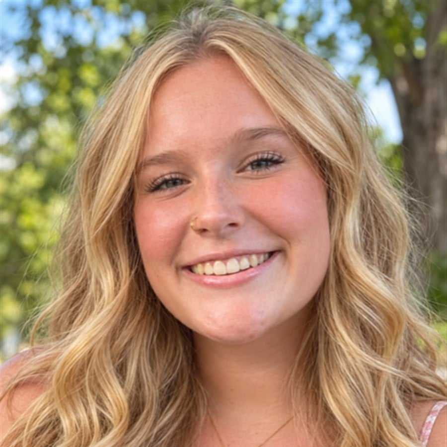 Portrait of Cassidy, a professional stylist at Head over Heels Salon, showcasing their expertise and style.
