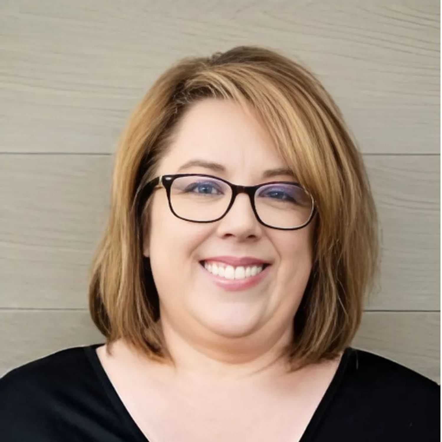 Portrait of Jen, a professional stylist at Head over Heels Salon, showcasing their expertise and style.