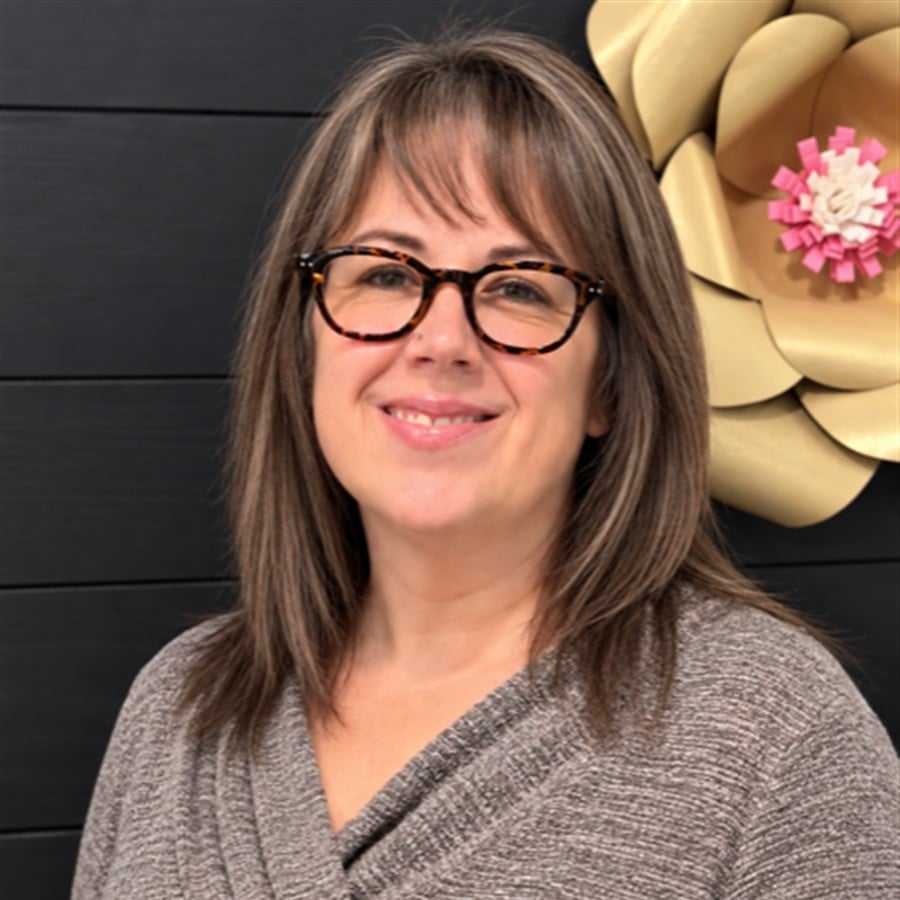 Portrait of Jen, a professional stylist at Head over Heels Salon, showcasing their expertise and style.