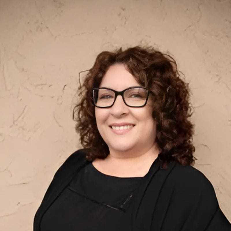 Portrait of Tina, a professional stylist at Head over Heels Salon, showcasing their expertise and style.
