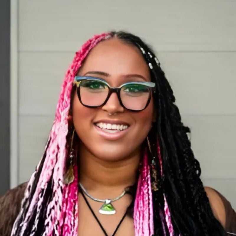 Portrait of Ayanna, a professional stylist at Head over Heels Salon, showcasing their expertise and style.